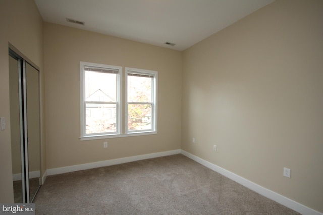 empty room featuring light carpet