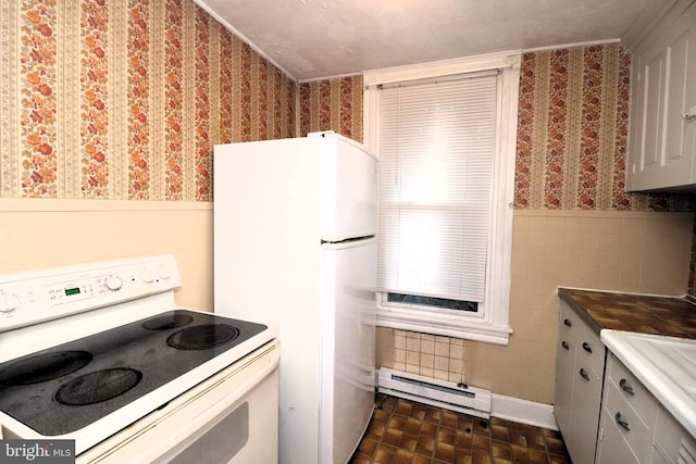 kitchen featuring white appliances and baseboard heating