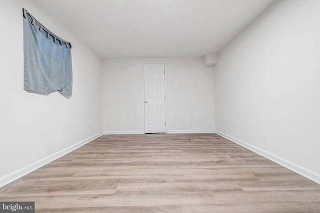 unfurnished room with light wood-type flooring