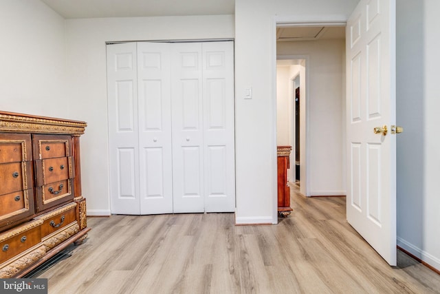 bedroom with a closet and light wood-type flooring