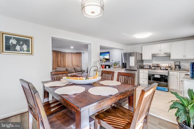 dining area with light hardwood / wood-style floors