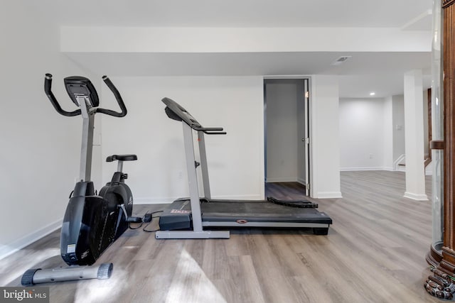 exercise room featuring light hardwood / wood-style floors