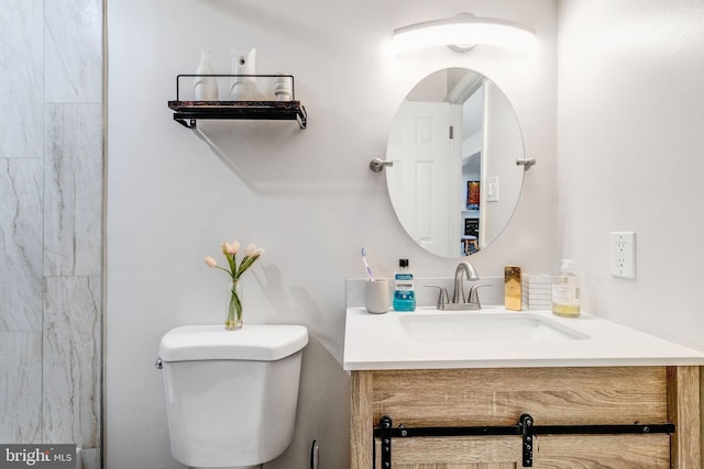 bathroom with toilet and vanity