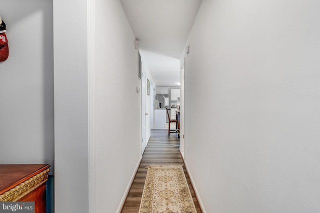 hallway with hardwood / wood-style floors