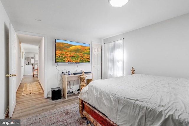 bedroom featuring light wood-type flooring and multiple windows