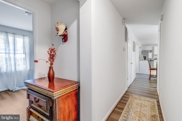 hallway with light hardwood / wood-style floors