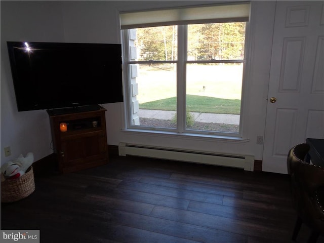 living room featuring a baseboard radiator, a healthy amount of sunlight, and dark hardwood / wood-style flooring