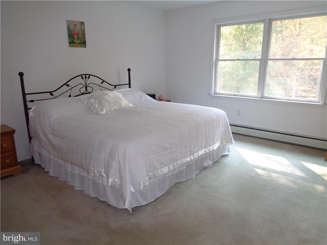 bedroom featuring light carpet and a baseboard heating unit