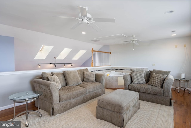 living room with light hardwood / wood-style floors and a skylight