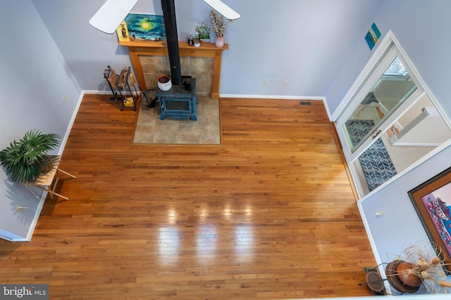 interior space with a wood stove and hardwood / wood-style flooring