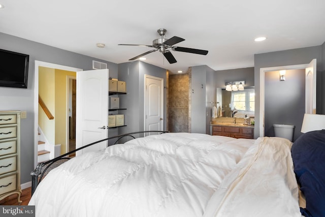 bedroom with ensuite bathroom, ceiling fan, and wood-type flooring