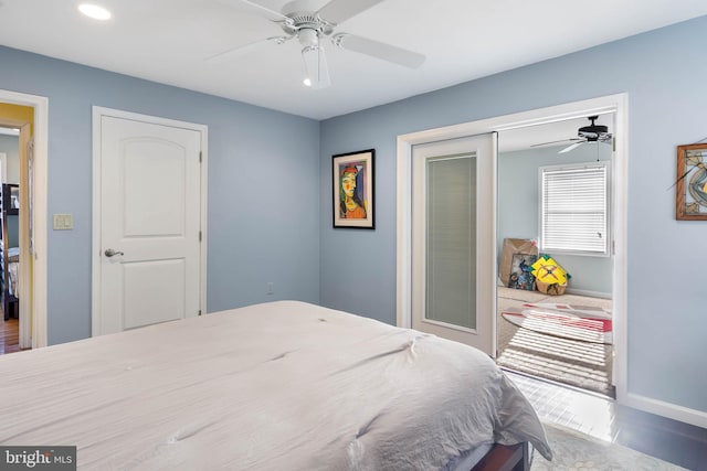 bedroom with a closet, hardwood / wood-style floors, and ceiling fan