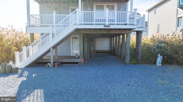 property entrance featuring a carport and a porch