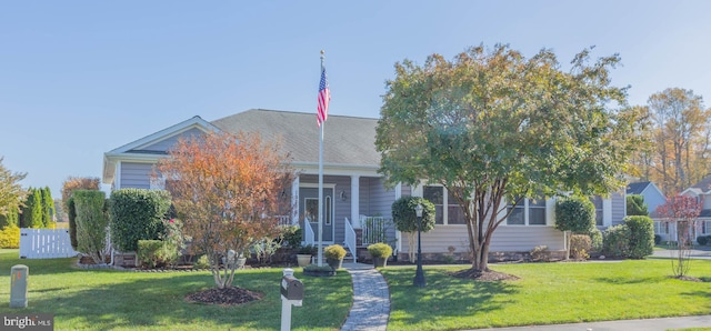 view of property hidden behind natural elements with a front lawn