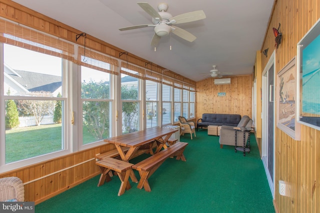 sunroom / solarium featuring ceiling fan and a wall mounted AC