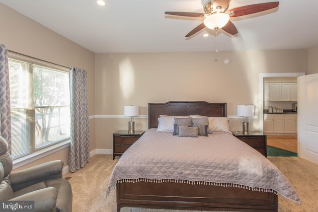 bedroom with ceiling fan and light carpet