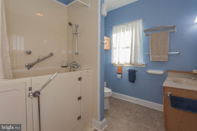 bathroom featuring vanity, tile patterned floors, and toilet