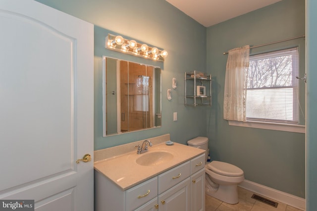 bathroom featuring vanity, tile patterned floors, toilet, and an enclosed shower