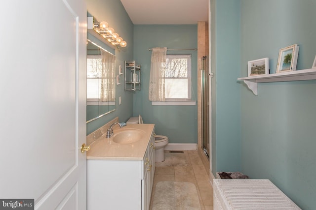 bathroom with vanity, a shower with door, tile patterned floors, and toilet