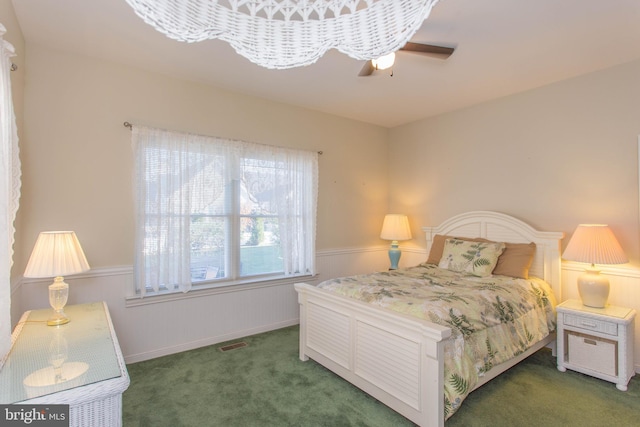 bedroom featuring ceiling fan and dark colored carpet