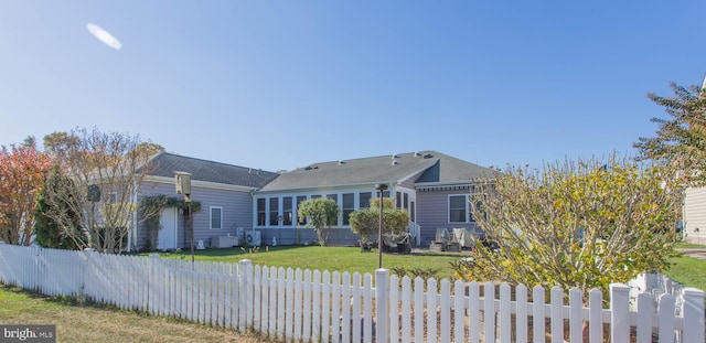 view of front of home featuring a front lawn and a sunroom