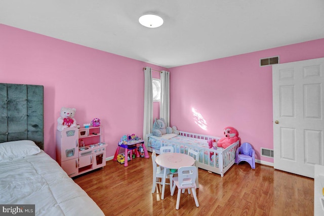 bedroom with wood-type flooring