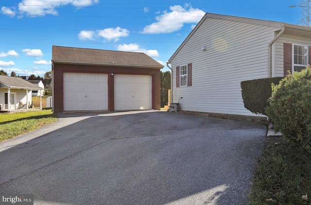 view of home's exterior featuring an outdoor structure and a garage