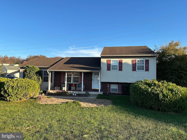 split level home featuring a front lawn