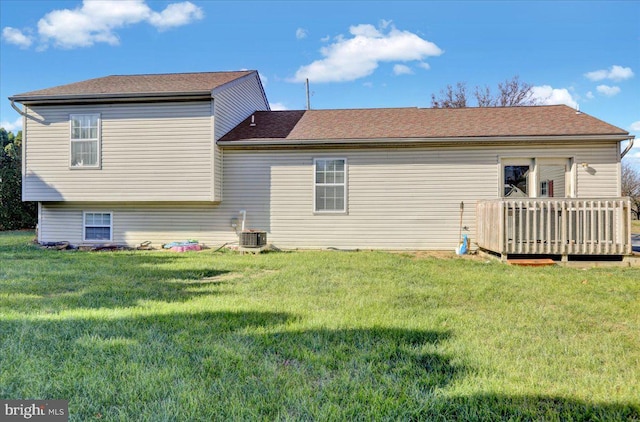 rear view of house with central AC, a lawn, and a wooden deck