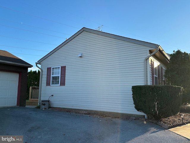 view of side of home with a garage