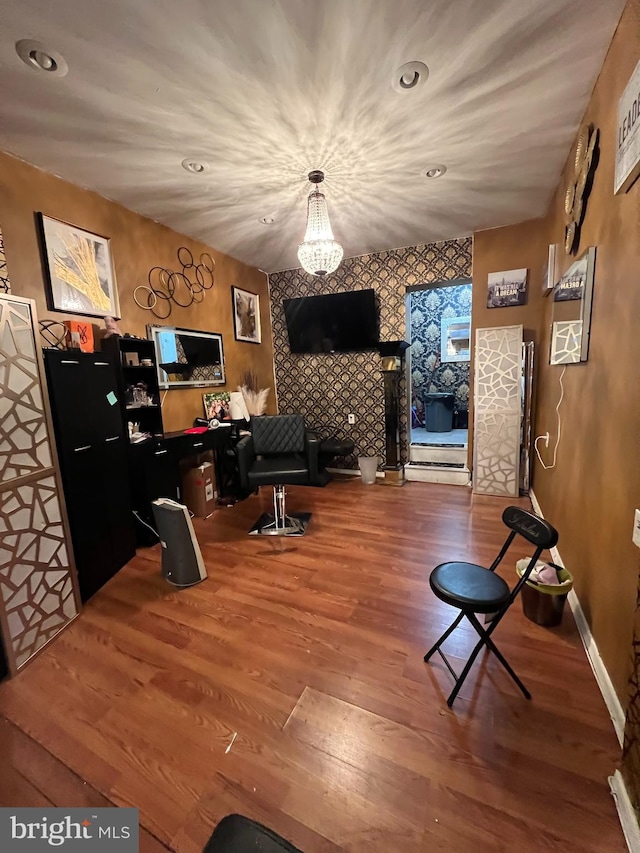 home office featuring wood-type flooring and an inviting chandelier