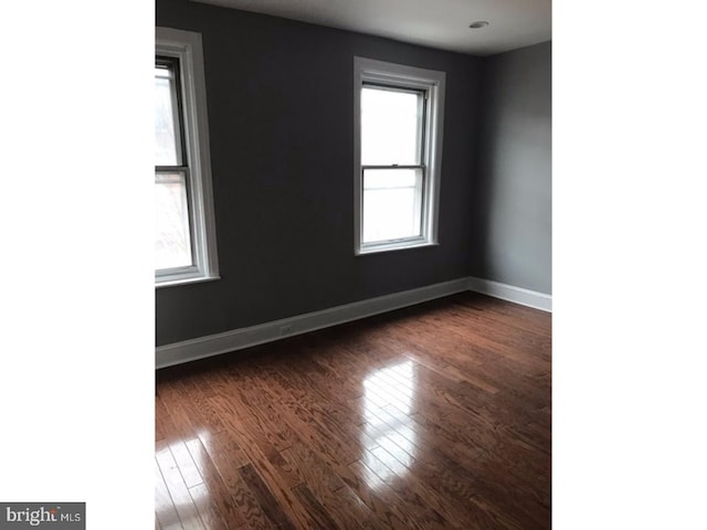 unfurnished room with dark hardwood / wood-style floors