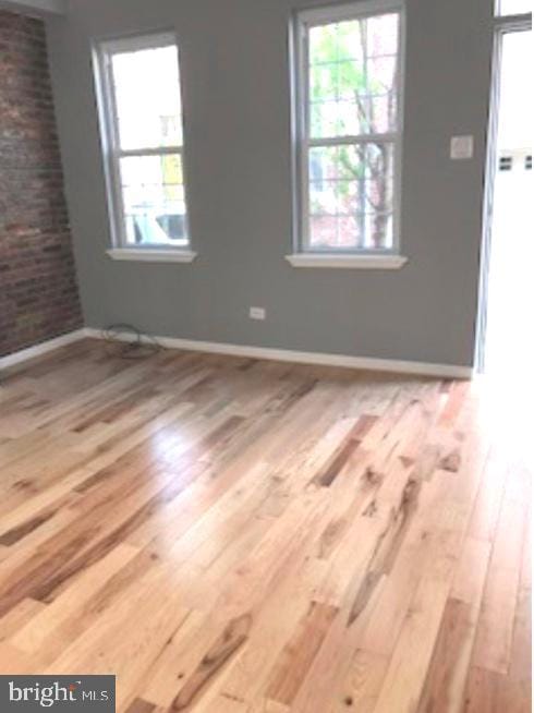 spare room with hardwood / wood-style floors