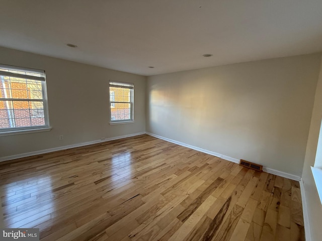 spare room featuring light hardwood / wood-style floors