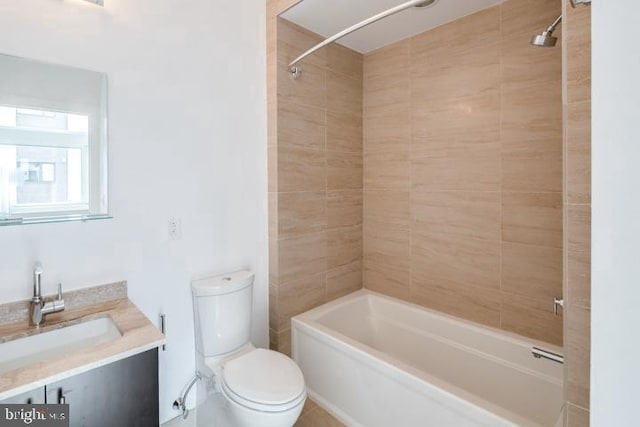 full bathroom with vanity, toilet, and tiled shower / bath combo