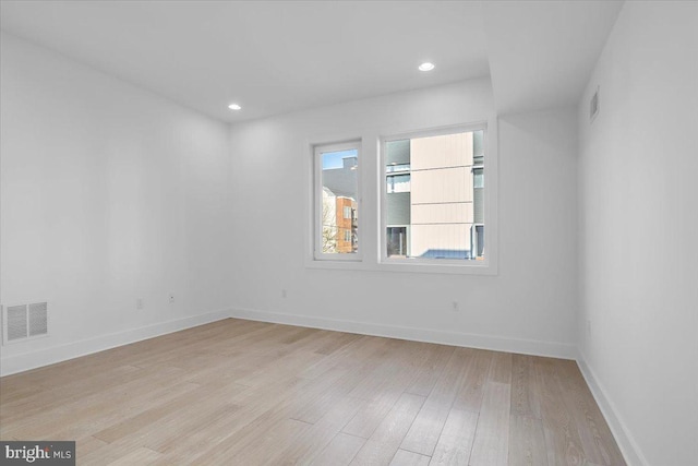 unfurnished room with light wood-type flooring