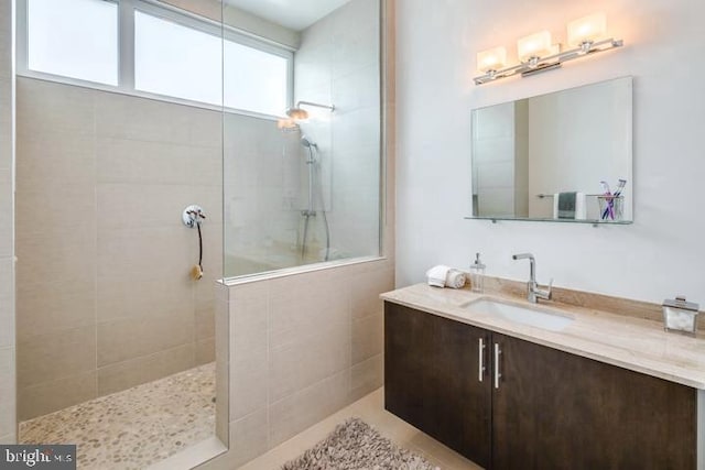 bathroom with vanity and tiled shower