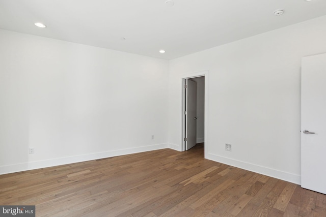 empty room with hardwood / wood-style flooring