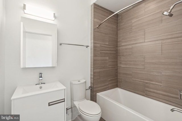 full bathroom featuring vanity, tiled shower / bath combo, and toilet