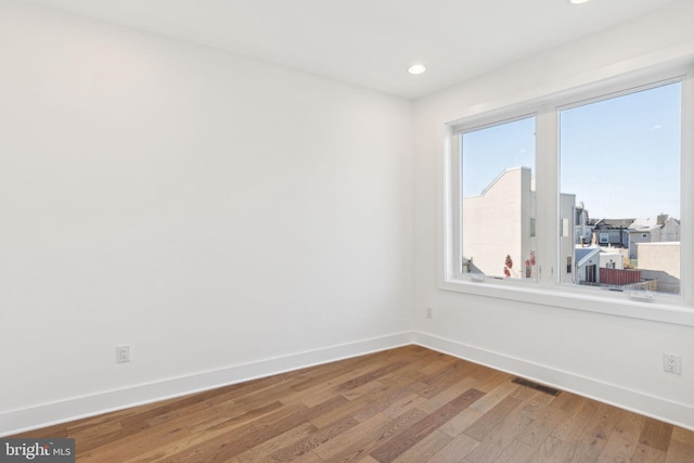 spare room with hardwood / wood-style flooring