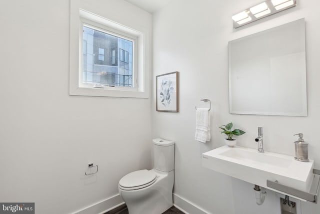 bathroom featuring toilet and sink