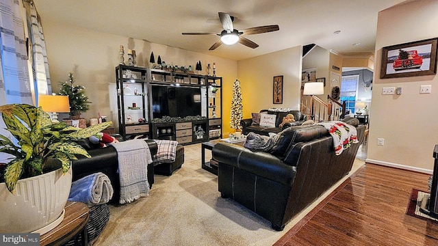 living room featuring hardwood / wood-style floors and ceiling fan