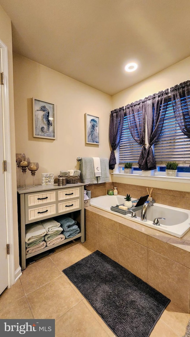 bathroom featuring tiled bath and tile patterned floors