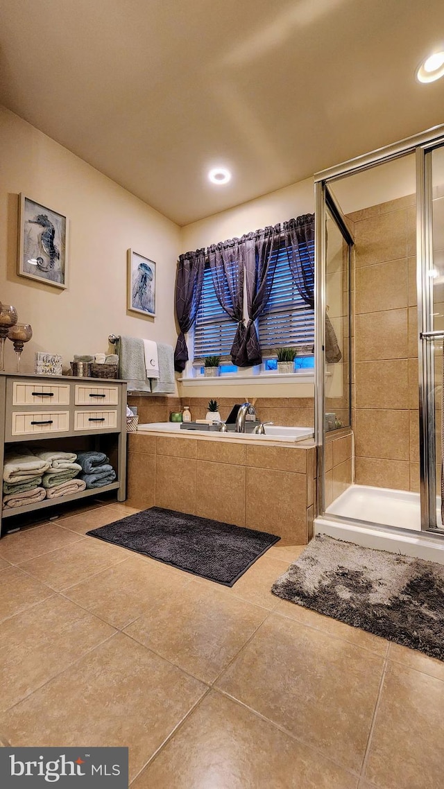 bathroom featuring tile patterned floors, independent shower and bath, and vanity