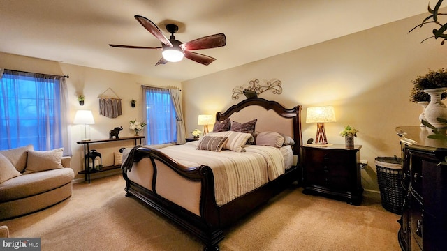 bedroom with ceiling fan and light carpet