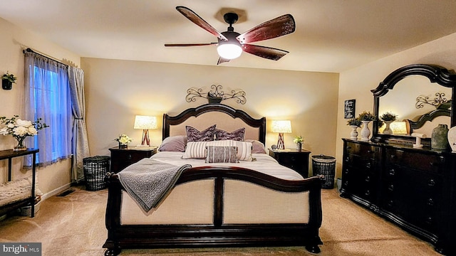 bedroom featuring light colored carpet and ceiling fan