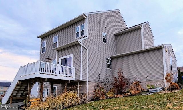 view of property exterior featuring a wooden deck and a yard