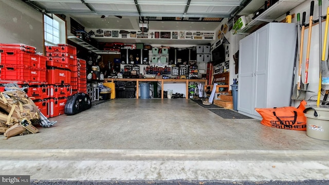 garage with a garage door opener and a workshop area