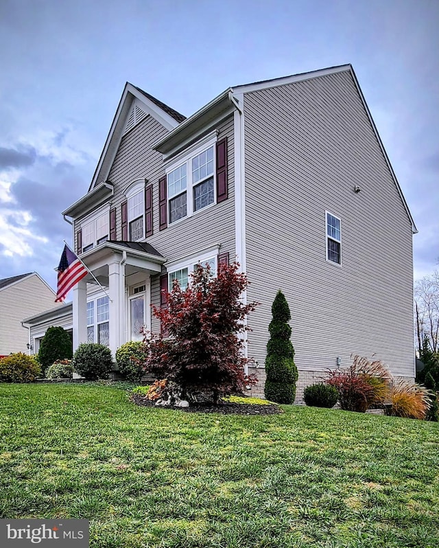 view of property exterior with a yard