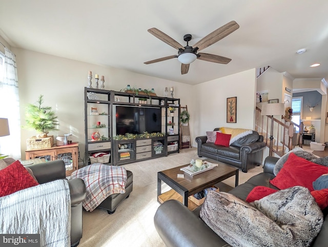 carpeted living room featuring ceiling fan